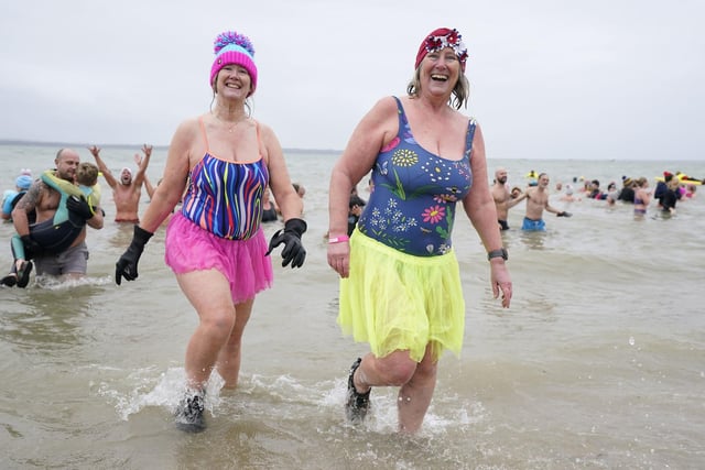 People take part in the Gosport New Year's Day Dip in The Solent at Stokes Bay, Gosport, Hampshire, to raise money for Gosport and Fareham Inshore Rescue Service.