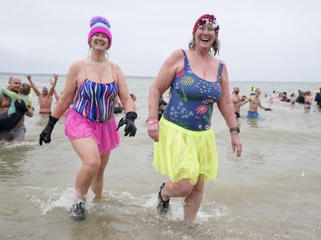 People take part in the Gosport New Year's Day Dip in The Solent at Stokes Bay, Gosport, Hampshire, to raise money for Gosport and Fareham Inshore Rescue Service.