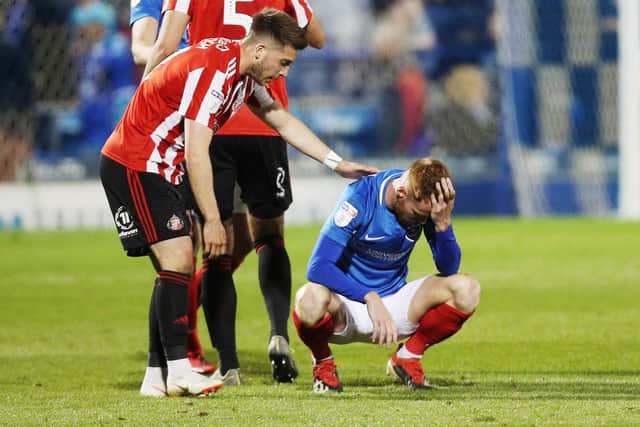 Tom Naylor is consoled following Pompey's play-off elimination at the hands of Sunderland last season