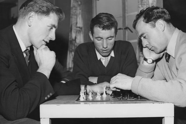 From left to right, Portsmouth footballers Fred Brown (1931 - 2013), Willie Morrison and Ron Saunders relax with a game of chess at their hotel in Saltdean, UK, 13th February 1959. They leave the next day for their Cup Match at Burnley. (Photo by Harry Todd/Fox Photos/Hulton Archive/Getty Images)