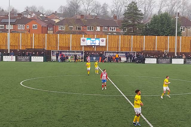 A very shallow standing area runs the whole length of one side of Dorking Wanderers' Meadowbank Stadium. Picture: Simon Carter