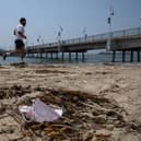 A man runs past a discarded face mask. Picture: Apu Gomes/AFP via Getty Images