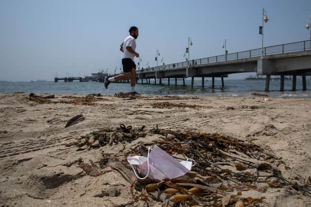 A man runs past a discarded face mask. Picture: Apu Gomes/AFP via Getty Images