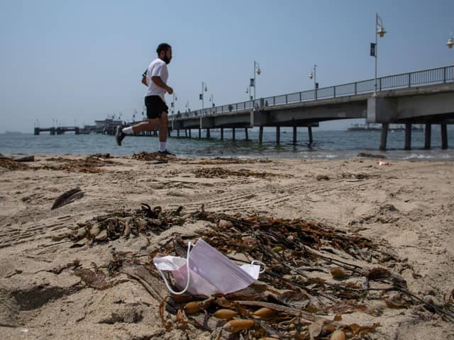 A man runs past a discarded face mask. Picture: Apu Gomes/AFP via Getty Images