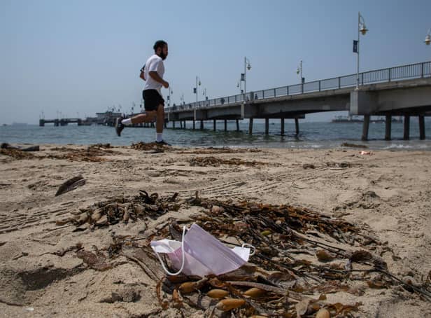 A man runs past a discarded face mask. Picture: Apu Gomes/AFP via Getty Images
