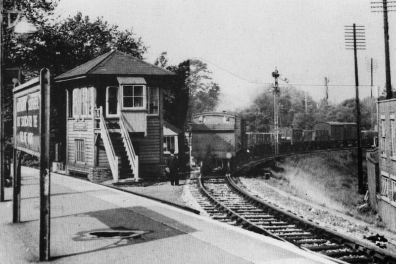 Passing the signal box, a train from the dockyard passes the home signal and comes onto the main line at Portsmouth & Southsea railway station High Level.