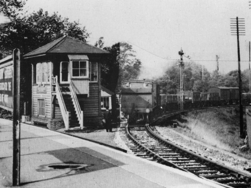 Passing the signal box, a train from the dockyard passes the home signal and comes onto the main line at Portsmouth & Southsea railway station High Level.