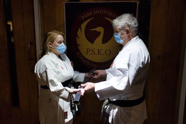 Black belt instructor Sam Lewington presenting the gift to Sensei Fletcher