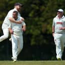 Denmead bowler Paul Charlton, second left, is congratulated on dismissing Waterlooville batter Spencer Hovey. Picture: Chris Moorhouse