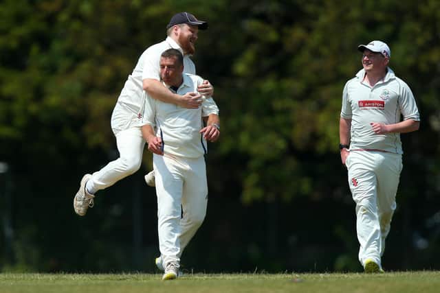 Denmead bowler Paul Charlton, second left, is congratulated on dismissing Waterlooville batter Spencer Hovey. Picture: Chris Moorhouse