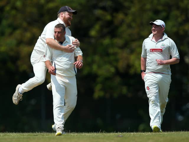 Denmead bowler Paul Charlton, second left, is congratulated on dismissing Waterlooville batter Spencer Hovey. Picture: Chris Moorhouse