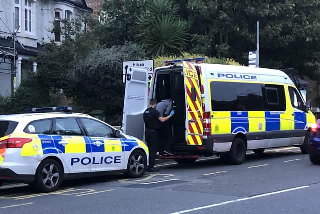 An officer leads a man into the back of a police van which had been parked outside a home in Kingston Crescent. Photo: Tom Cotterill