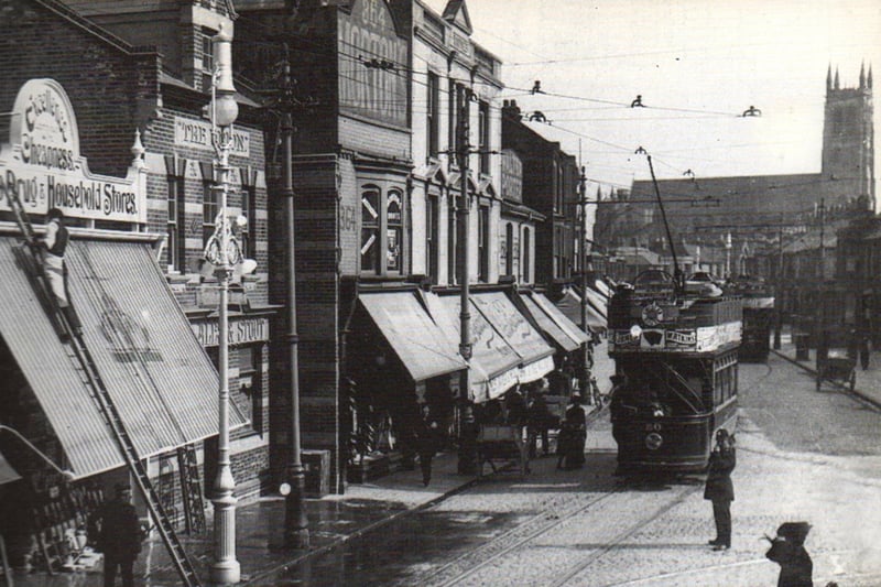 Kingston Road at its Junction with Lake Road in 1934. A policeman directs traffic to and from Lake Road leading to the right of the photograph Looking a very prosperous part of town  most of what we see has all been demolished. St Mary's Church tower stands on guard further south.