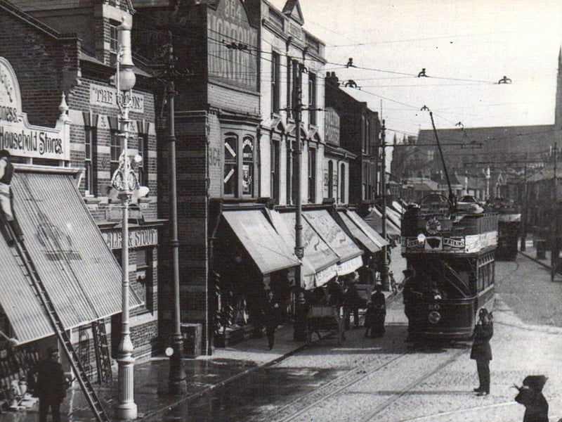 Kingston Road at its Junction with Lake Road in 1934. A policeman directs traffic to and from Lake Road leading to the right of the photograph Looking a very prosperous part of town  most of what we see has all been demolished. St Mary's Church tower stands on guard further south.