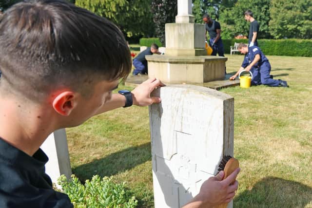 Personnel from HMS Sultan cleaning Commonwealth War Graves at St Ann’s Hill Cemetery. PictureL Royal Navy.