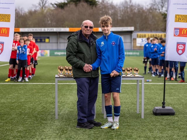 James Sykes receives the player of the match award from John Carter, chairman of the Portsmouth Youth Football League. Picture: Mike Cooter