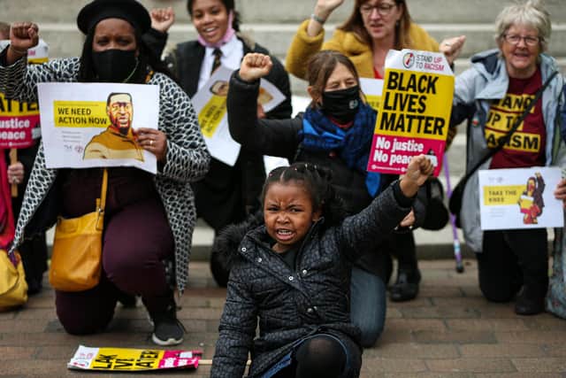 Nala-Paris Mbah, five, centre. Black Lives Matter campaigners take a knee in Guildhall Square, Portsmouth, on the first anniversary of the death of George Floyd at the hands of police in Minneapolis, US.
Picture: Chris Moorhouse