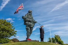 Jan Zawada plays The Last Post next to the Yomper statue. Picture: Mike Cooter (210522)