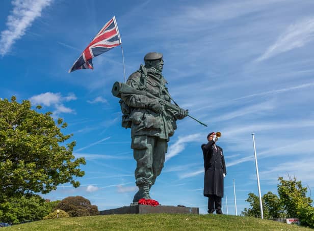 Jan Zawada plays The Last Post next to the Yomper statue. Picture: Mike Cooter (210522)
