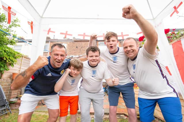Darren Archer and his father in law, Cliff Williams will be on opposite side of the fence during England and Scotland's clash at the Euros tomorrow.

Pictured: Cliff Williams and Darren Archer with his children, Troy 12, Cody 15 and Reece 14 at Darren's home in Milton, Portsmouth on 17 June 2021

Picture: Habibur Rahman