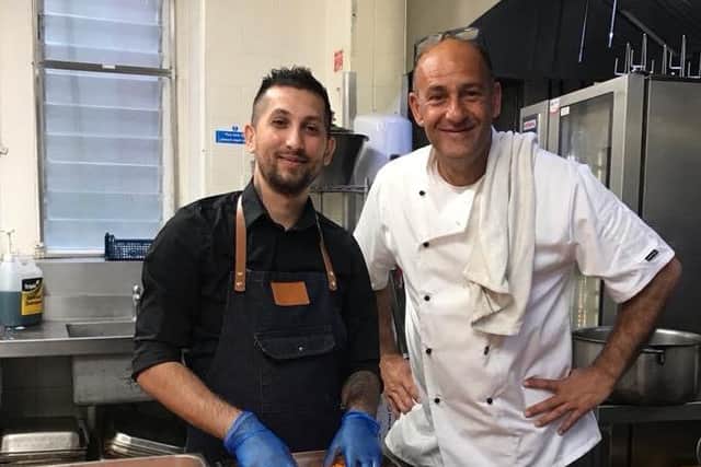 Niko the chef and Farid Yeganeh, right, cooking the meals. Picture: Queens Hotel.