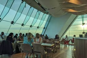 Guests inside the Sky bar enjoying cocktails and spectacular views of the city.