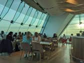 Guests inside the Sky bar enjoying cocktails and spectacular views of the city.