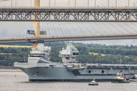 HMS Queen Elizabeth passes under the Forth Bridges as she heads back to sea following lengthy time at Rosyth for repairs and upgrades due to mechanical fault.    July 22, 2024.