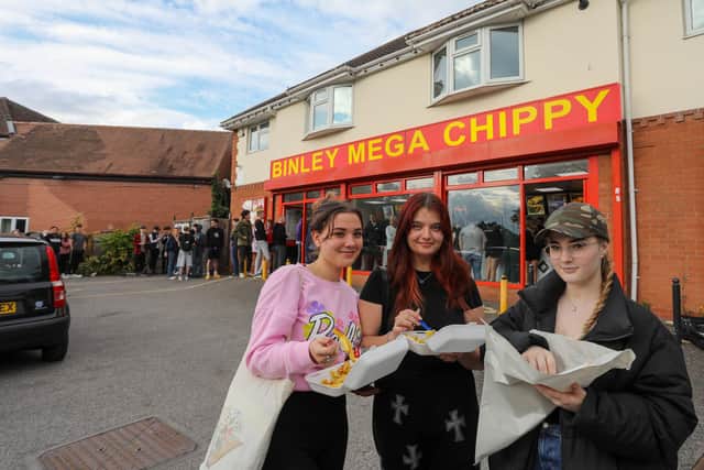 From left, Erika, Maggie and Jagoda from Coventry eating their chips outside Binley Mega Chippy in Coventry Picture: SWNS