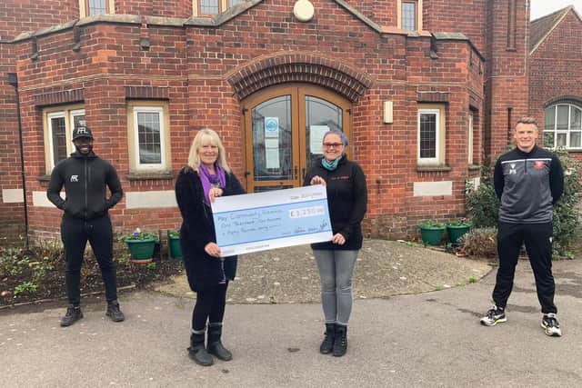 Peter Sanderson, far right, and Warren Chebby present a cheque for £1,250 to the Portchester Food Pantry last December. Julie Sexton (second left) and Lucy-Anne Barnett, who run the Pantry out of the Methodist Church, are holding the cheque.