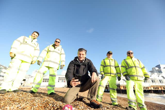 Steve Bomford photographs plastic waste on Southsea beach with members of the Colas team, from left, Paul Fuller, Tony White, Robbie White and Keith Yarrow. The Jetsam app will then allow the team to find it and clear it. Picture: Chris Moorhouse (150120-19).