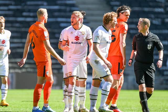 The Milton Keynes Dons players react to a foul from Portsmouth FC defender Jack Whatmough (6) during the EFL Sky Bet League 1 match between Milton Keynes Dons and Portsmouth at stadium:mk, Milton Keynes, England on 17 April 2021. Picture: Dennis Goodwin
