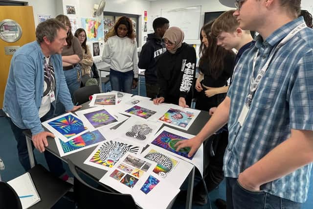 Mark designing the mural with his students.