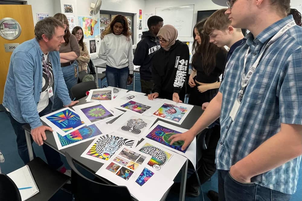 Mark designing the mural with his students.