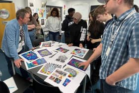 Mark designing the mural with his students.