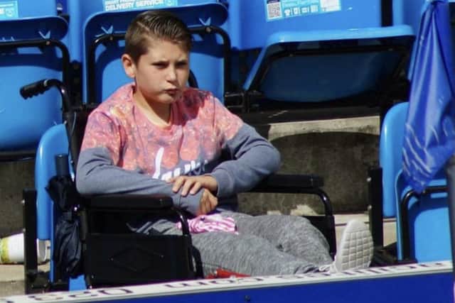Alfie Bridgman at Fratton Park in his wheelchair to watch brother Stan in action in 2015