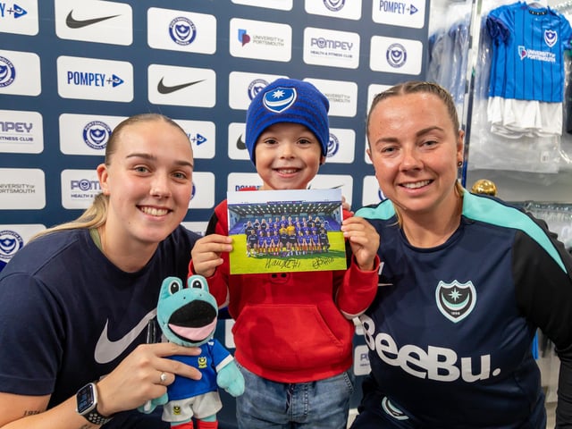 Oscar Elsbury (5) gets a signed squad photo with Ella Humphrey (winger, 20) and Hannah Haughton (keeper, 32) from Portsmouth FC Ladies. Picture: Mike Cooter (011124)