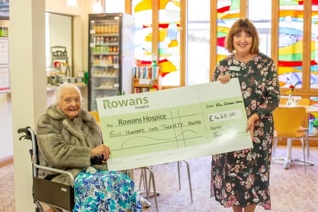 Joan Eddings giving a cheque of £420 to Ruth White, CEO of Rowans Hospice. Picture: Habibur Rahman