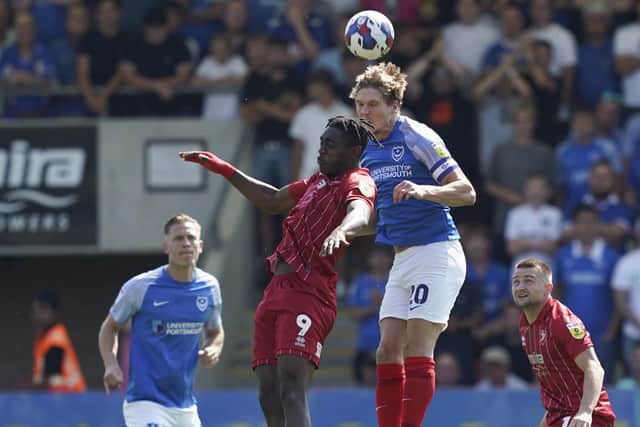Sean Raggett wins this aerial battle with Cheltenham's on-loan Southampton striker Dan Nlundulu    Picture: Jason Brown