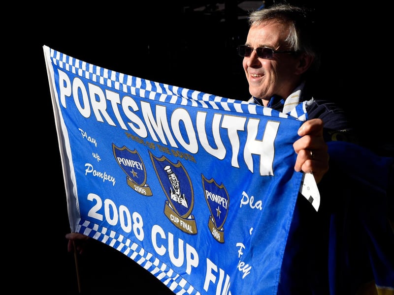 A Pompey fan with a flag prior to the FA Cup tie with AFC Bournemouth at Fratton Park in January 2016. Photo by Mike Hewitt/Getty Images