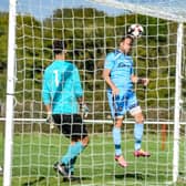Brett Pitman heads home one of his four FA Vase goals against East Cowes. Picture by Daniel Haswell.