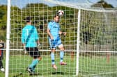 Brett Pitman heads home one of his four FA Vase goals against East Cowes. Picture by Daniel Haswell.