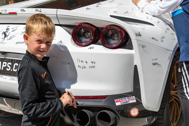 Finn Welfare (6) added his signature to the Ferrari 812 Superfast. 
Picture: Mike Cooter (290723)