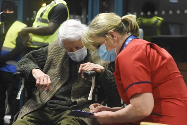 Chief Nurse Liz Rix talking through the vaccine procedure with Michael Tibbs, 99.

© Ewan Galvin/Solent News & Photo Agency