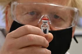 Prime Minister Boris Johnson holding a vial of the Oxford/AstraZeneca Covid-19 candidate vaccine, known as AZD1222, at Wockhardt's pharmaceutical manufacturing facility in Wrexham, North Wales. Picture: Paul Ellis/PA Wire