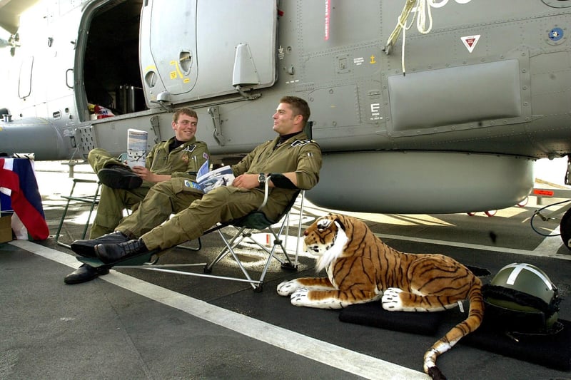 IFOS 27th August 2001. (left to right) LAC Stu Worley (29) and Lt Neil Parrock (29) with 'Tigger' on the flight deck of HMS Illustrious as they relax during public tours of the ship. Picture: Malcolm Wells 014499-12