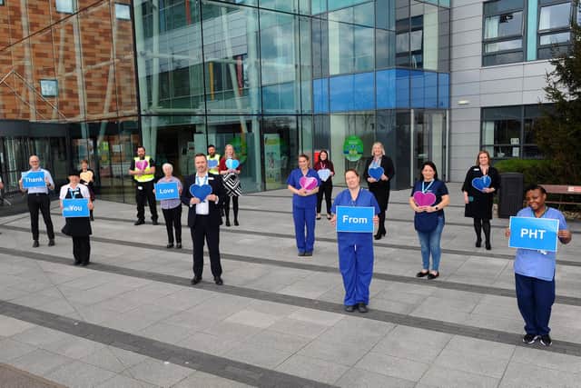 Staff at Queen Alexandra Hospital in Cosham, show their appreciation to the community of Portsmouth. Mark Cubbon, chief executive of Portsmouth Hospitals Trust, with just some of staff at QA saying thank you. Picture: Sarah Standing (030420-7678)