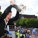 David Nugent lifts the FA Cup during Pompey's open-top bus celebrations. Picture: Joe Pepler