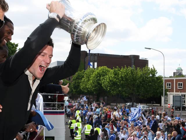 David Nugent lifts the FA Cup during Pompey's open-top bus celebrations. Picture: Joe Pepler