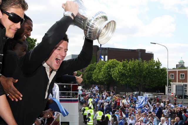 David Nugent lifts the FA Cup during Pompey's open-top bus celebrations. Picture: Joe Pepler